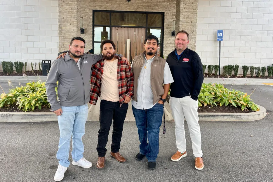 The Air Company Partners posing for a photo in front of an hvac building