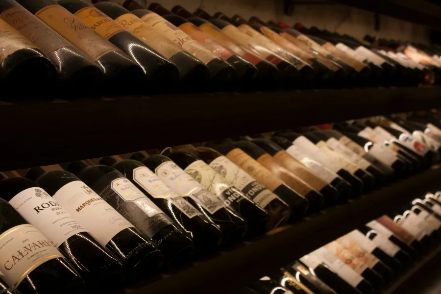 a shelf full of wine bottles