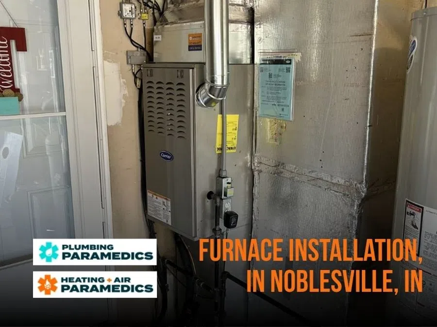 New Carrier furnace installed in Noblesville, Indiana utility room with Plumbing and Heating Air Paramedics logos.
