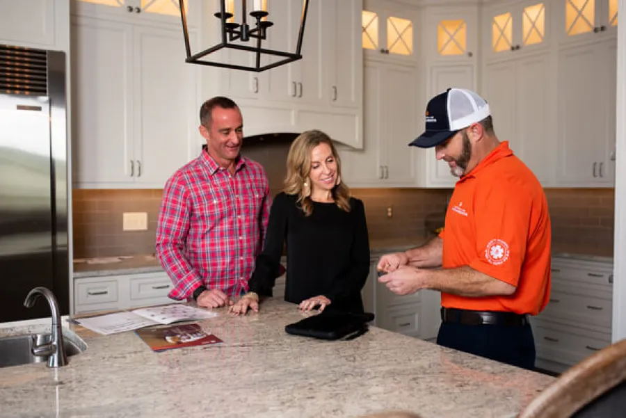 a group of people standing around a kitchen counter