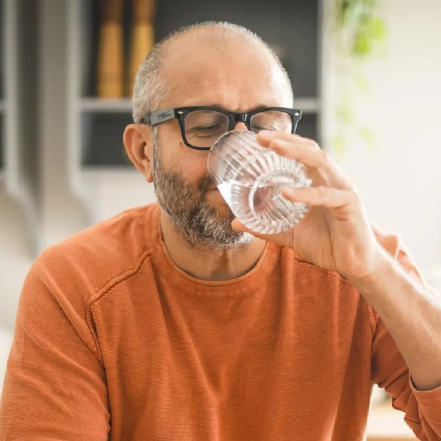 a man drinking from a glass