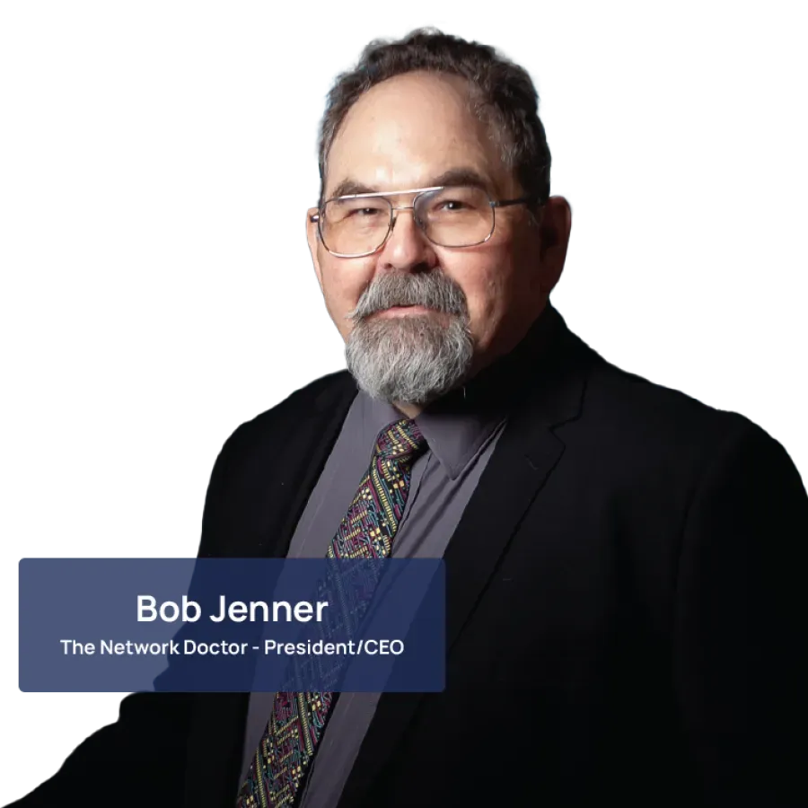 Professional portrait of a mature man with glasses and beard wearing a suit and patterned tie on black background