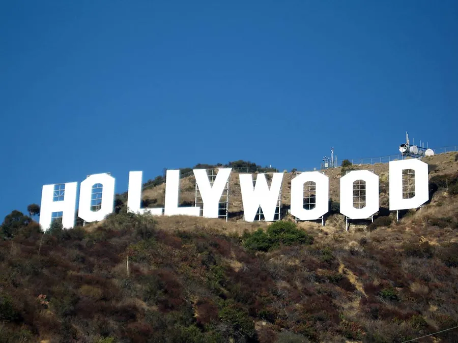 White Hollywood sign on a hillside under a clear blue sky in Los Angeles, California.