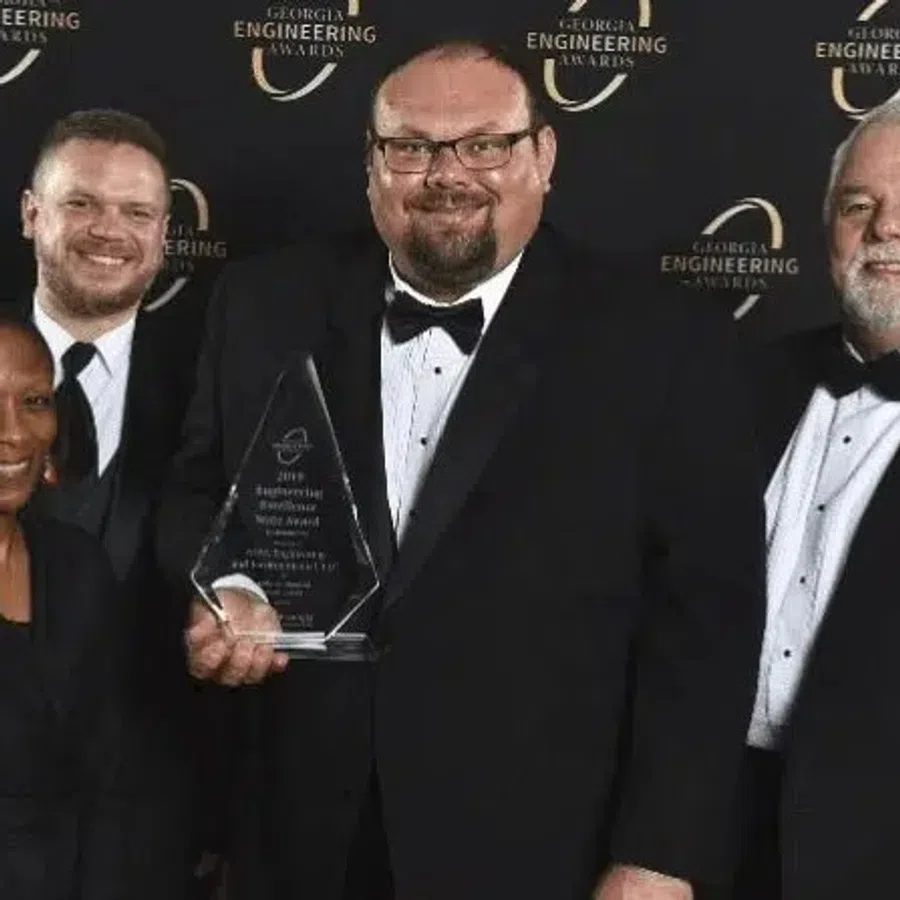 Four people in formal attire posing with an award at the Georgia Engineering Awards event.