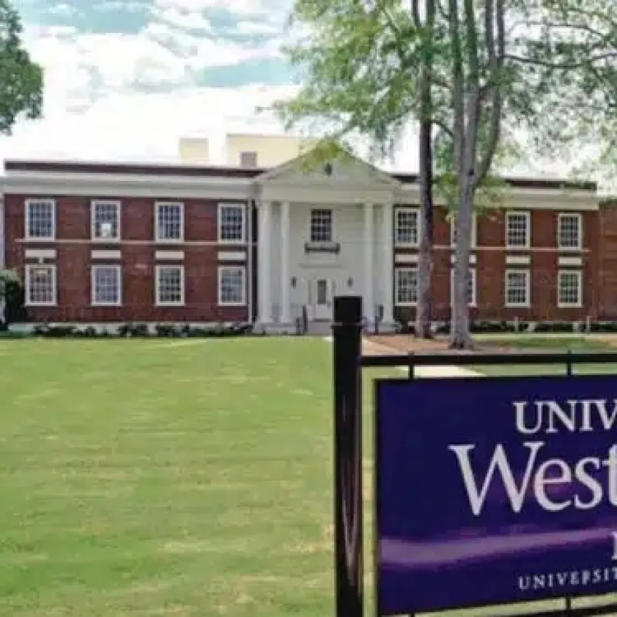 University of West Georgia Newnan campus building with sign and green lawn under blue sky.
