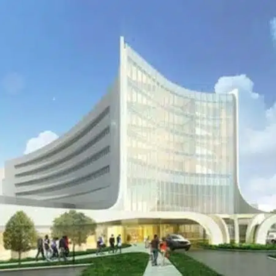 Modern curved glass office building with people walking and cars parked under a clear blue sky