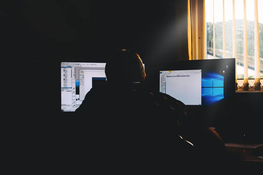 a person sitting in front of a computer