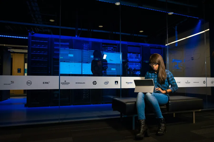 a person sitting on a bench with a laptop