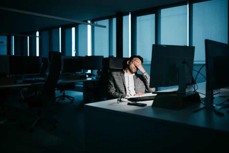 a person sitting at a desk with a computer