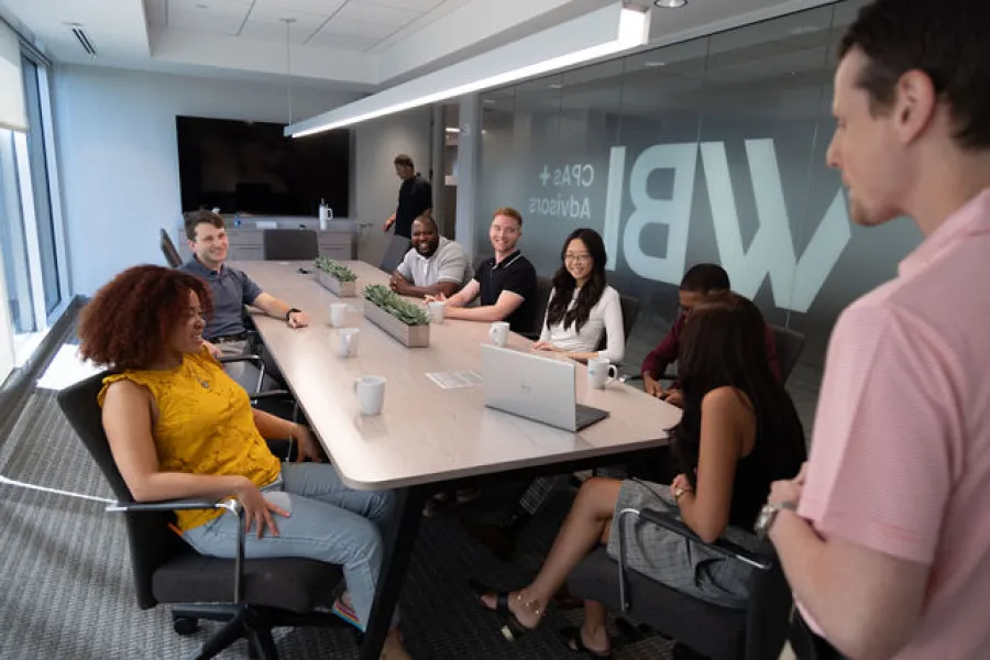 a group of people sitting around a table