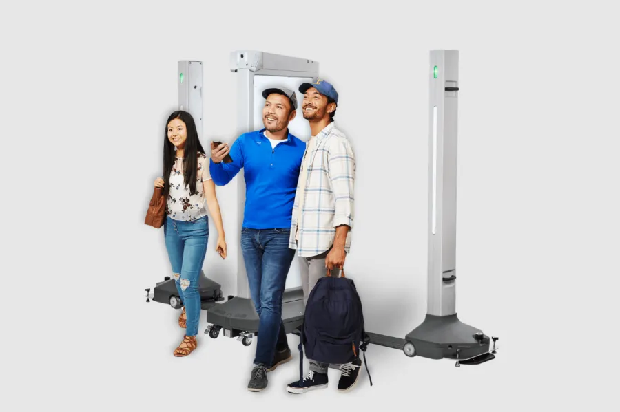 people walking through an Evolv express weapons detection system