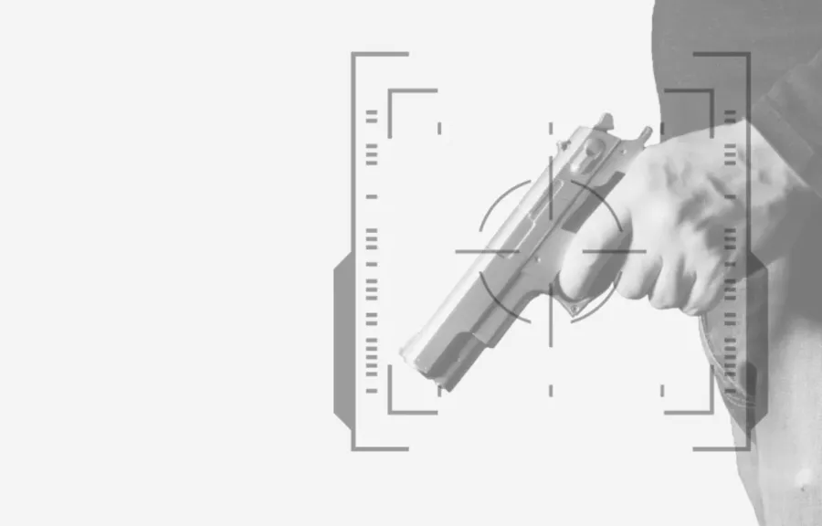 Right hand holding silver handgun with digital target overlay on a plain white background.