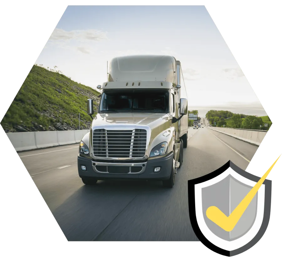 White semi-truck driving on a highway with green hills and clear sky in the background