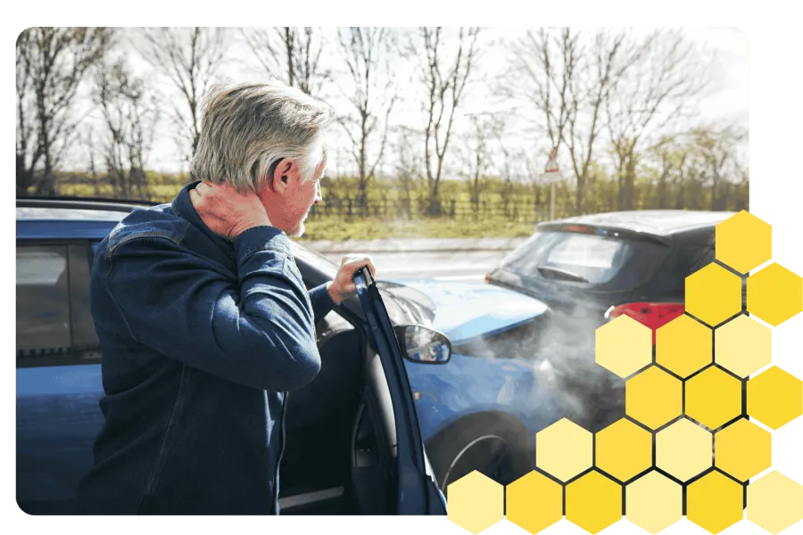 Senior couple smiling and talking with a healthcare professional in a bright, cozy kitchen setting.