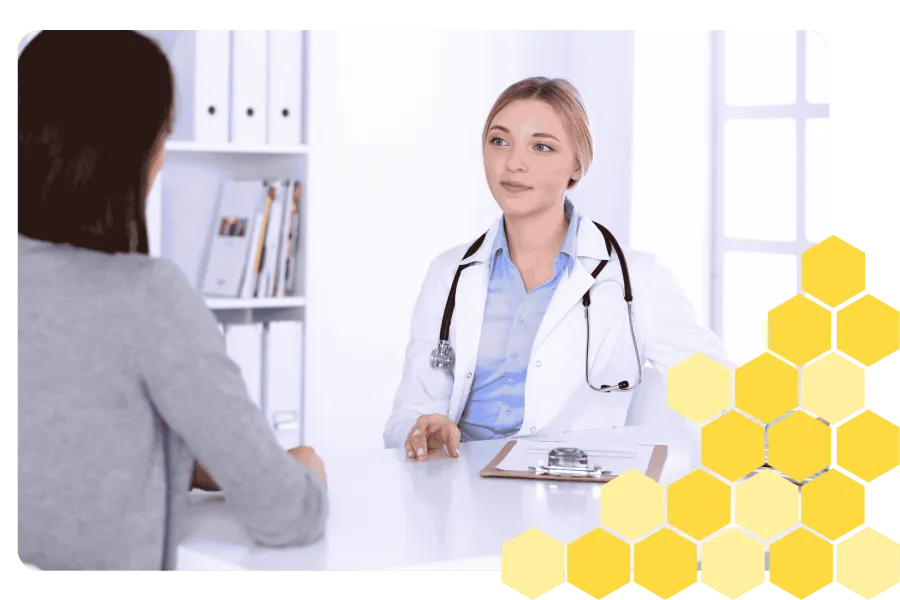 Female doctor with stethoscope consulting patient in modern medical office setting
