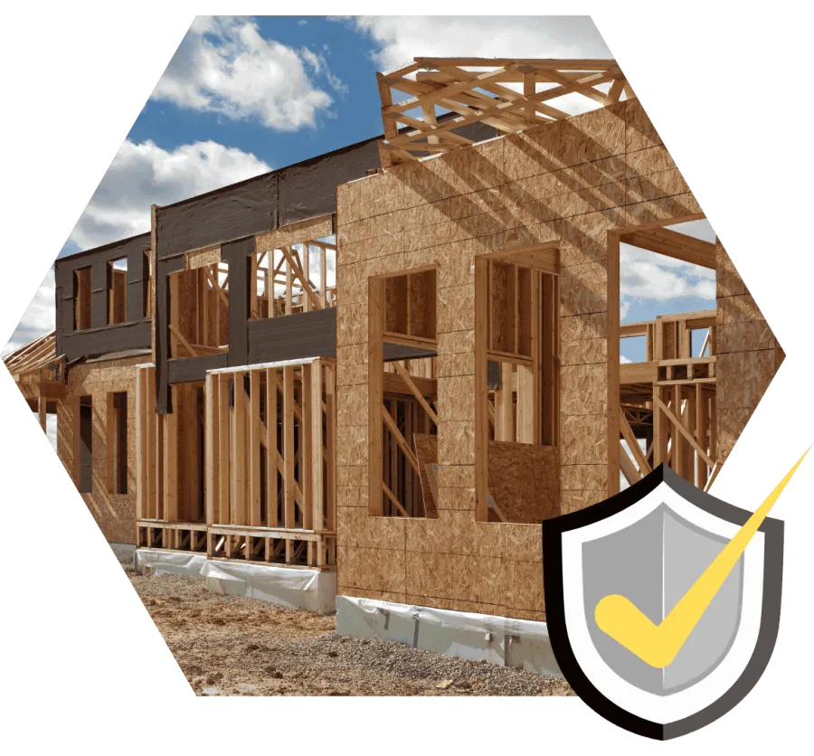 Wooden frame of a house under construction on a clear day with blue sky and clouds.