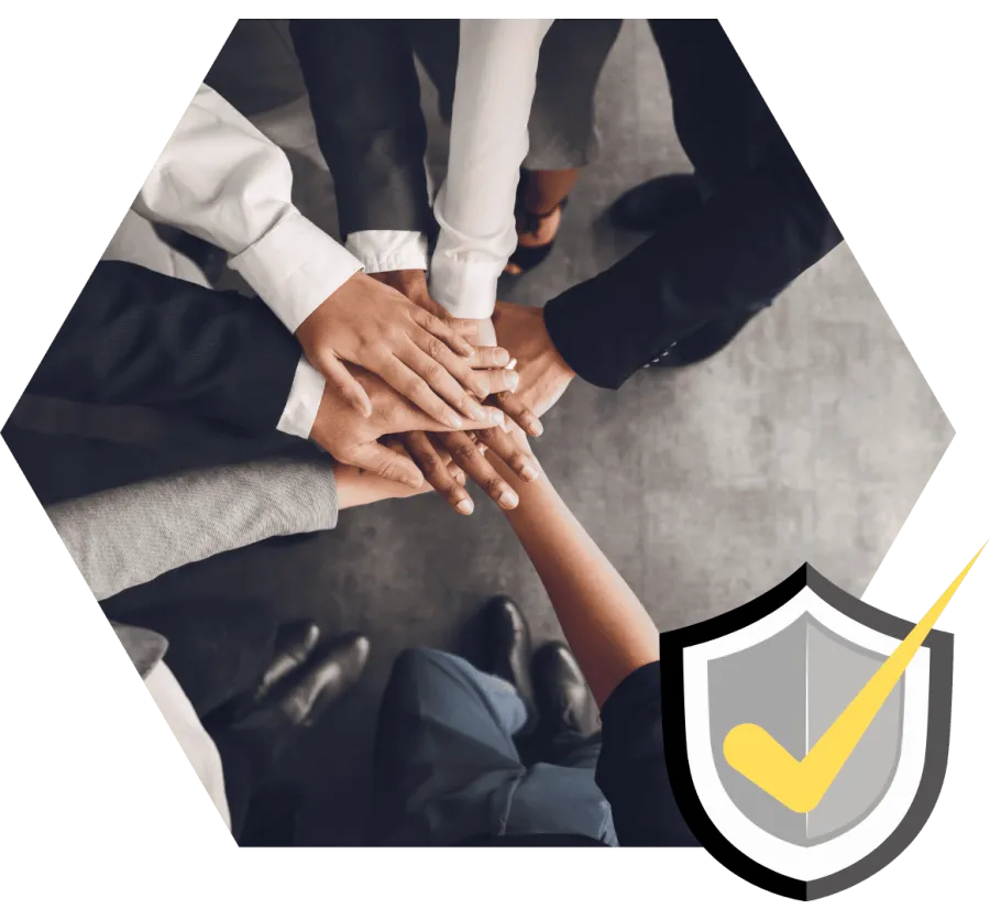 Diverse business team stacking hands in unity over gray floor symbolizing teamwork and collaboration.