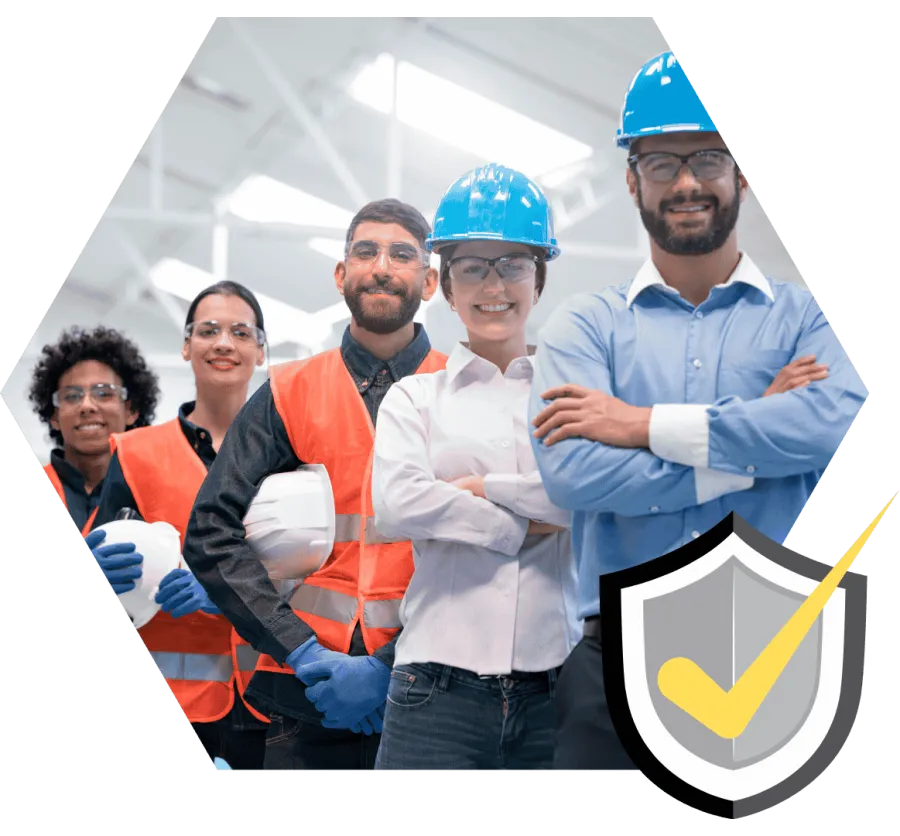 Diverse group of construction workers and engineers posing with safety gear and helmets in a bright industrial setting