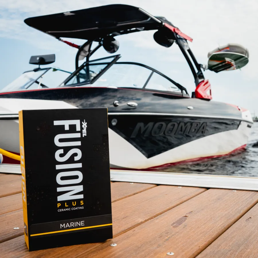 XL Fusion Plus Marine ceramic coating box placed on dock with Moomba boat in background on water.